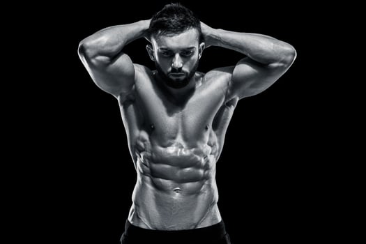 Muscular bodybuilder guy doing posing photo