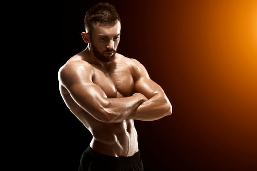 Muscular bodybuilder guy doing posing photo