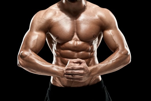 very muscular man posing with naked torso in studio photo