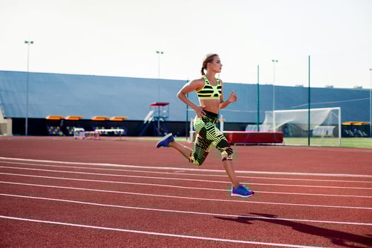 Beautiful young woman exercise jogging and running on athletic track on stadium. photo