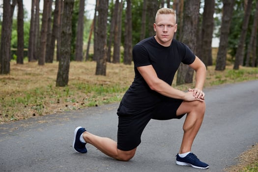 young athlete running in the forest photo