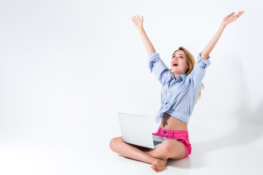 young woman sitting on the floor and using laptop photo