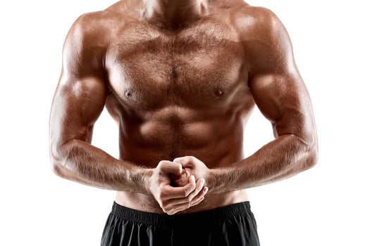 Portrait young sexy handsome man of strong athlete's body with bare torso. Posing on white studio background photo