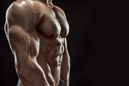 Muscular bodybuilder guy doing posing over black background photo