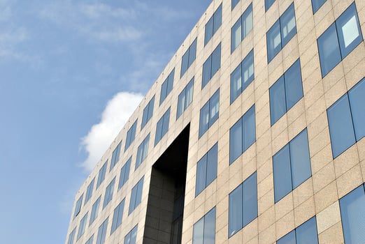 Abstract closeup of the glass-clad facade of a modern building covered in reflective plate glass. Architecture abstract background. Glass wall and facade detail. photo