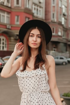 A young teenage girl in a white dress and hat photo