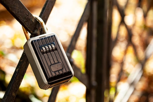 There's a black coded lock hanging on the fence. Private area with limited access. Protected gated area. photo