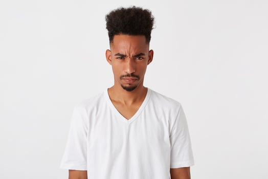 Portrait of mad displeased african american young man with afro hairstyle wears photo