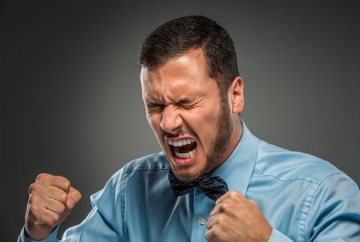 Portrait angry upset young man in blue shirt, butterfly tie photo
