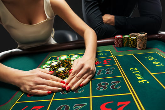 Couple playing roulette wins at the casino. photo