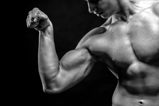 Close-up of man flexing showing his triceps, biceps muscles photo