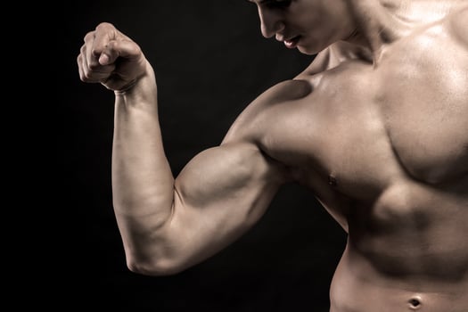 Close-up of man flexing showing his triceps, biceps muscles photo