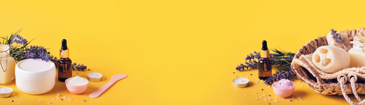 Yellow banner with lavender cosmetics products and place for text. Home body skin care, Spa setting photo