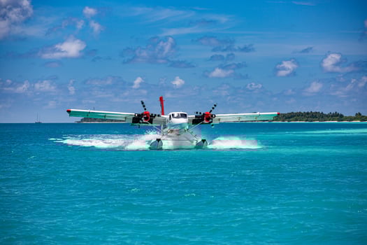 Exotic scene with seaplane on Maldives sea landing. Vacation or holiday in Maldives concept background, luxury travel transportation exotic destination scenic photo