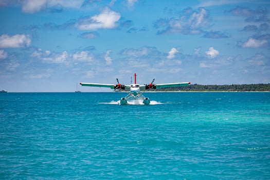 Exotic scene with seaplane on Maldives sea landing. Vacation or holiday in Maldives concept background, luxury travel transportation exotic destination scenic photo