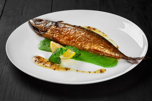 Grilled mackerel with green pea puree, herbal sauce and lemon photo