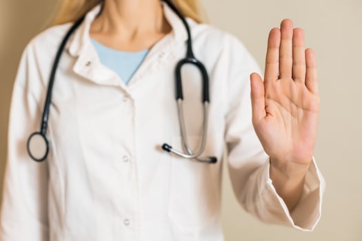 Image of female doctor showing stop sign. photo