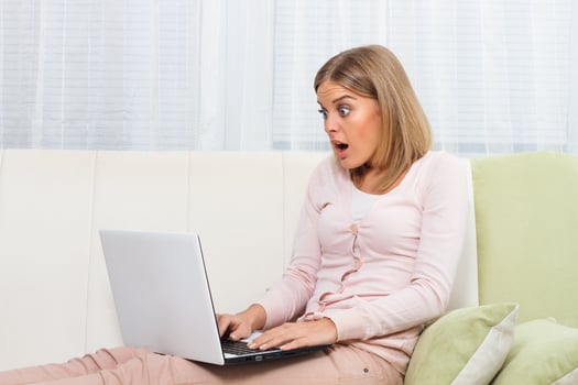 Shocked woman using laptop photo