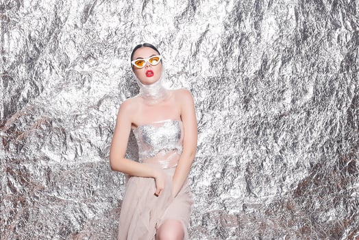 Young beautiful girl on a silver background. photo