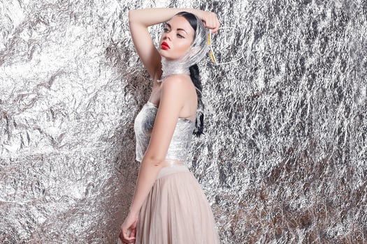 Young beautiful girl on a silver background. photo