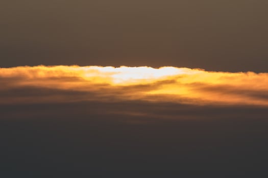 Orange stratus clouds shining above the beach and the horizon photo