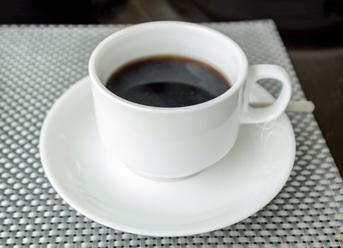 Black coffee in white ceramic cup photo