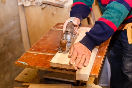 Carpenter works in a workshop for the production of vintage furniture photo