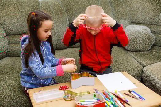 primary school children boy and girl are engaged in creative hand-made art at the table at home photo