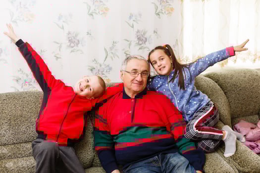 grandfather spends time with grandchildren in the living room photo