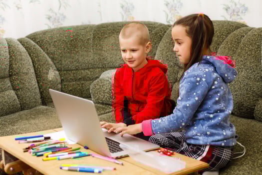 Distance learning online education. school boy and girl studying at home with laptop notebook and doing homework. Sitting at a table photo