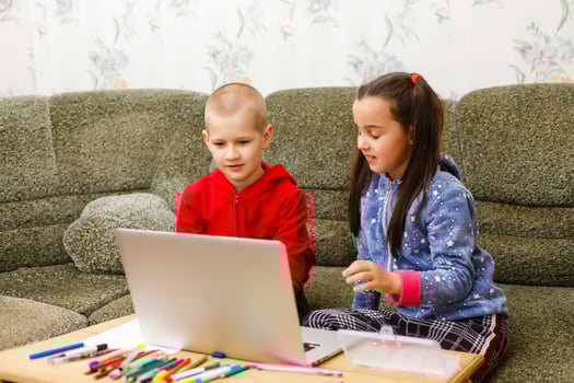 Distance learning online education. school boy and girl studying at home with laptop notebook and doing homework. Sitting at a table photo