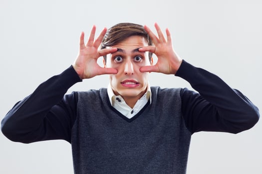 Businessman with his hands on eyes staring photo