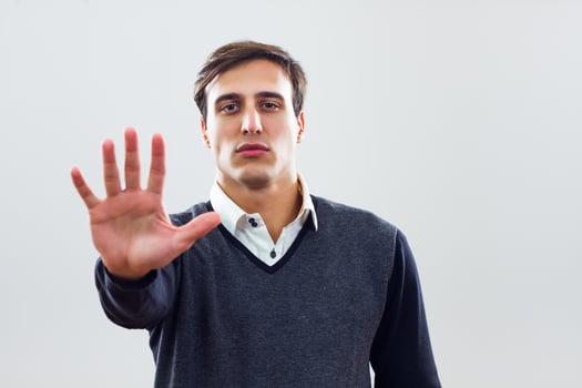 Businessman showing stop sign photo