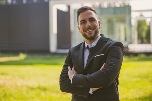 Portrait of elegant businessman enjoys standing outdoor.Toned photo