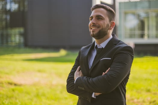 Portrait of elegant businessman enjoys standing outdoor.Toned photo