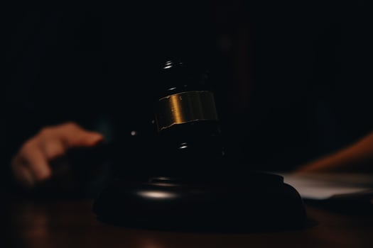 Business and lawyers discussing contract papers with brass scale on desk in office. Law, legal services, advice, justice and law concept picture with film grain effect photo