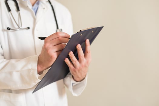 Image of male doctor writing notes. photo