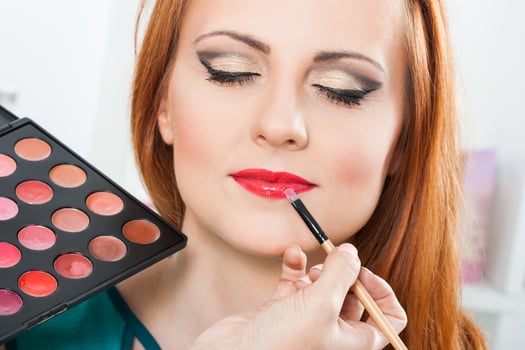Make up artist applying  make up on a beautiful woman photo