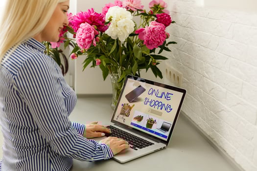 woman holding laptop for online shopping photo