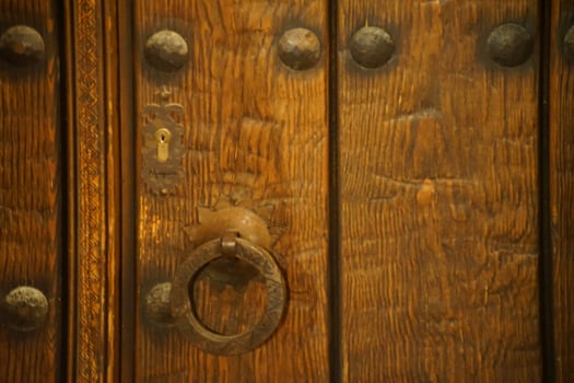 Very old wooden door with knocker photo