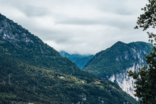 Beautiful landscape with alpine peaks and white clouds in Italy. photo