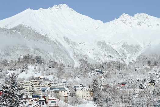 Beautiful landscape of winter white snowy mountains with little houses in Innsbruck. photo