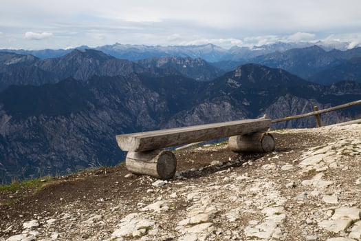 Empty lonely bench on top of the alpine mountains in Italy. photo