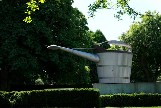 statue in the form of a huge watering can watering the garden Beacon Hill park Victoria Canada BC photo