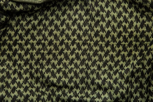 Keffieh scarf. The texture of the cotton traditional symbolic arabian scarf. Khaki back. photo