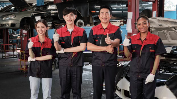 Portrait of multiracial professional mechanic team thumbs up and look at camera, work at car service garage, happy maintenance jobs, check and repair occupation in automotive industry business. photo