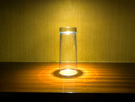 An objects is displayed on the table with a spotlight photo