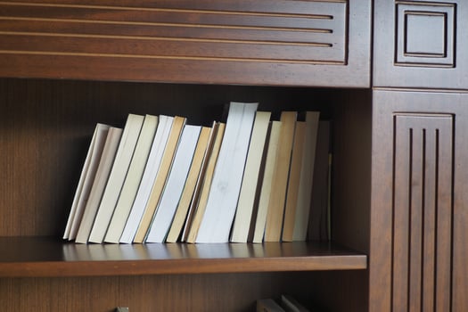 A lot of books are on the shelf in a public library or bookstore photo