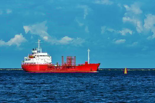Red cargo tanker ship moving by the river photo