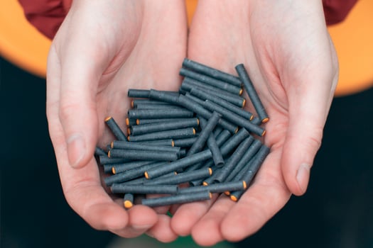 Man Holding Small Black Firecrackers in his Hand. Guy Getting Ready for New Year Fun CloseUp Shot photo